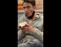 Guy eats coconut cut in half on subway