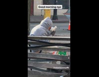 Guy kisses snowman toy on public bench
