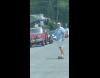 blue shirt visor skating down street