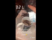 Cup moves while girl pours chocolate powder 