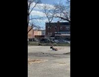 Guy sunbathes in middle of parking lot