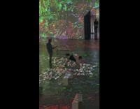 Woman in black dress white top yoga pose inside the exhibit