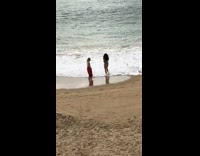 Two women red bottoms bikini beach dance