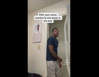 Guy blue shirt walks into kitchen 