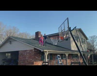 Little girl does underhand bball shot from roof