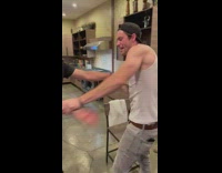 Guy in white tanktop smashes beer on head and drinks