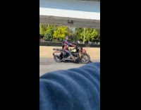 Man on motorcycle wearing captain america costume 