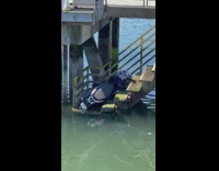 Motorcycle on stairs in water connecting to dock