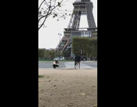 Woman black coat walk pedestrian lane Eiffel Tower