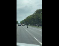 Man rides unicycle hoverboard on road 