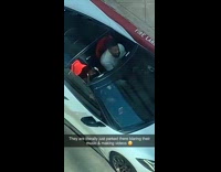 Guy sing in white convertible sports car