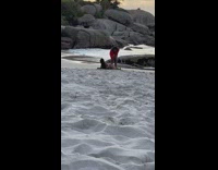 Woman lie down while other woman takes picture behind