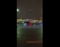 Bunch of people poses and takes picture in the middle of the road