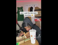 Guy eating mcdonalds in room red lights 