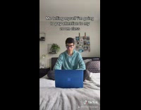 Blue sweater guy zoom class laptop bed 