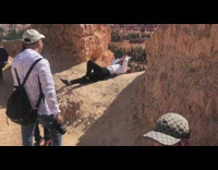 Lady leans over cliff edge for photo