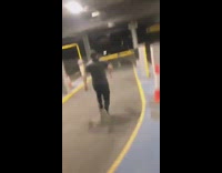 Drunk guy runs and jumps over parking lot gate, break yellow arm and falls on the ground