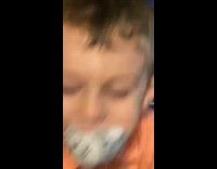 Boy kid orange shirt eat stuffed toy