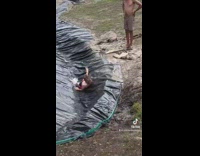 Kid slides down on a water slide 