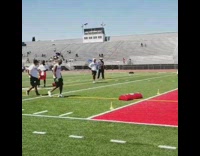 Coach throws red tackle pad at high schooler football players at practice