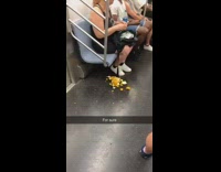 Woman peels orange and puts orange peel pile on subway floor