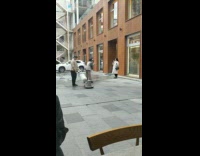 Guy cleans ground around girl taking photos