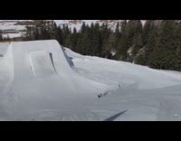 Skier does a triple flatspin 900 flip off big ramp and lands backwards