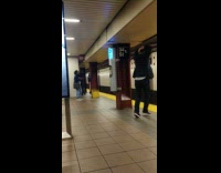 Man in suit yells out loud in another language at subway station 34th street