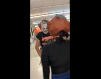 Three kids wear clown masks and dance 