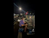 Guy riding scooter on parking lot 