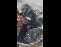 Guy in scuba gear goes into thick dirty sewer hole