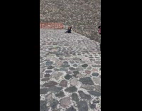 Girl on cobble stone floor takes selfie