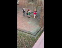 Girl wearing red santa skirt poses outside 