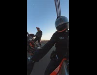 Woman rides motorcycle on road 