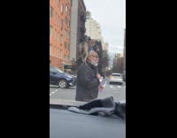 Man walks with dog standing on shoulder