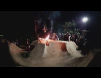 Guy riding bicycle does backflip over fire