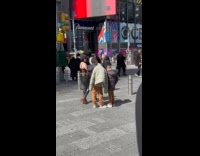 Woman selfies kids beside her at sidewalk