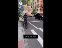Colorful Plastic Bags Creep Up Behind Biker 