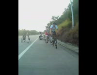 Guy throws red can out open window 