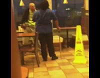 Old guy fighting with fast food worker in blue uniform