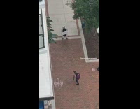 Guy wears panda onesie holds white sign 