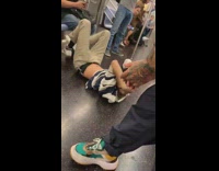 guy in striped shirt hangs and falls off subway ceiling 