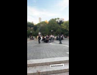 Gooners anonymous sign beside people at park