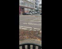 Woman white pants hop spin pedestrian lane