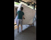 Guy brings white mattress on train dolly