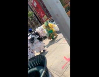 Three people in large paper dresses in circle