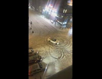 Car doing donuts on empty snow covered road