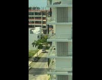 Woman dress dance on balcony building dog