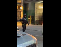 Security officer with Batman mask at street
