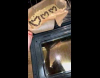 Lady Puts Batter on Mold Inside Oven